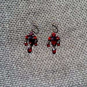 Red antique looking drop earring.